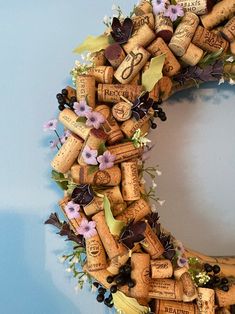 a wreath made out of wine corks and flowers