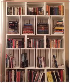 a bookshelf filled with lots of different types of books on top of it