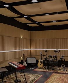 a recording room with guitars, keyboards and other musical equipment