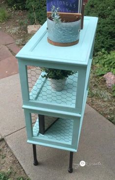 a blue table with a potted plant on top