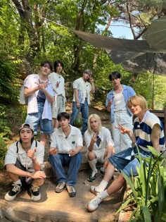 a group of people sitting on steps in the woods