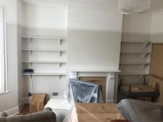 an empty living room with white walls and open shelves