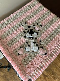 a crocheted blanket with a teddy bear on it