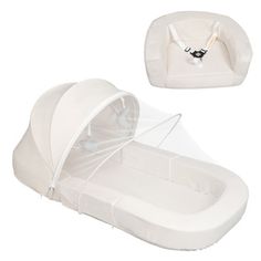 a white baby bassinet with mosquito netting on it