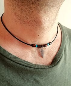 Leather cord choker necklace with stainless steel feather pendant and wooden beads brown turquoise colors, lobster clasp closure. Wooden beads rope necklace with feather lucky charm will be a great gift for him. All metal components are stainless steel. Feather pendant: 25 x 5 mm wooden beads: 4 mm, 10x6 mm For all products are used only genuine high-quality Italian leather, natural stones and wood. All metal materials are lead and nickel free.  /Gift wrapping and packaging/ :   All items ordered will be placed in a gift bag and shipped in a bubble mailer. /Jewelry care instructions/: Not recommended bathing, physical activity, swimming, sleeping while wearing jewelry. It may damage all the components of the product. Feather Pendant Necklace, Beaded Rope, Leather Chokers, Jewelry Care Instructions, Feather Pendant, Rope Necklace, Stainless Steel Pendant, Mens Accessories Fashion, Short Necklace