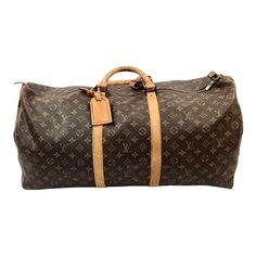 Timeless early 20th century Louis Vuitton Keepall travel Bag in classic monogrammed leather. Gold brass hardware, padlock and leather trim/tag all have the unique Louis Vuitton monogram. No key available.  Has double leather handles, 4.75" drop. Lightweight overnight or weekender bag. Travel Bag With Brass Hardware And Monogram Canvas, Luxury Bag In Monogram Canvas With Brass Hardware, Classic Bags In Monogram Canvas With Lock, Classic Bag With Lock In Monogram Canvas, Classic Bags With Lock In Monogram Canvas, Classic Monogram Canvas Bag With Lock, Classic Travel Bag With Lock, Classic Travel Bag In Monogram Canvas, Brown Monogram Canvas Bag With Palladium Hardware