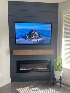 a flat screen tv mounted above a fireplace