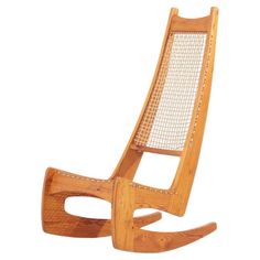 a wooden rocking chair that is made out of wood and has mesh on the back