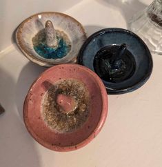 three different bowls sitting on top of a white counter