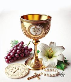 a golden chalice with flowers, grapes and a medal on the table next to it