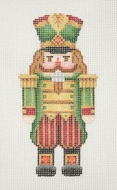 a cross - stitch pattern of a nutcracker in green and gold with red stripes