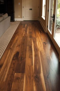 a living room with wood flooring and sliding glass doors