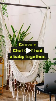 a white hammock hanging from a ceiling in front of a laptop on a table