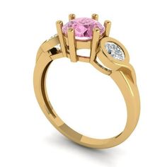 a pink diamond ring with two white diamonds on the band and an oval shaped center stone