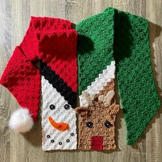 two knitted christmas ties on top of a wooden floor