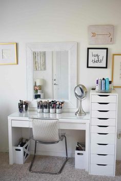 a white desk topped with lots of drawers and a mirror over it's top