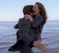 two people are hugging in the water