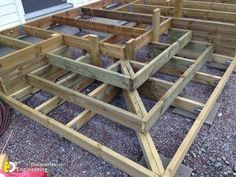 several wooden benches sitting on top of gravel