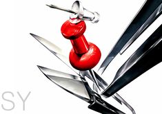 a pair of scissors with red knobs attached to each one's blade and the word easy on it