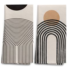 two black and white towels with an abstract design on the front, one in beige