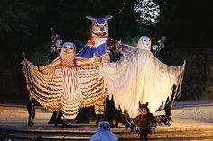 an elaborately decorated float in the shape of owls and ghost's on display