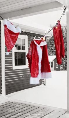 santa claus's clothes are hung on the porch