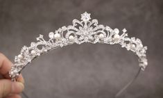 "Pearl & Crystal Wedding Tiara, Bridal Tiara, Pearl Wedding Headpiece, Pearl Wedding Tiara, Crystal Wedding Crown, Bridal Headpiece This elegant and sparkle rhinestone Tiaras is perfect for your wedding or formal night out. This Tiaras is flexible. It will be perfect for the bride. The Metal Headband measured approx. 14\" long. The rhinestone part of the headband is about 9\" long and the center is 1.25\" high. Tone color: Silver tone, Gold tone and Rose gold tone. Pearl color : Swarovski wh Bridal Crown Pearl, Small Tiara Wedding Bridal Hair, Vintage Wedding Tiara, Pearl Tiara Wedding, Princess Tiaras, Tiara Bride, Pearl Headpiece Wedding, Prom Tiaras, Crystal Headpiece Wedding