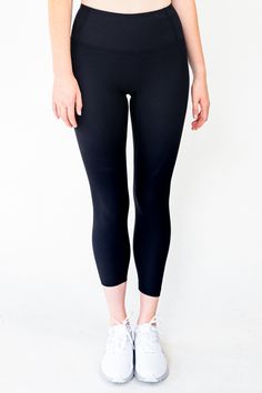 The Linear Legging in Black combines fashion and function, with a 4-way stretch ribbed fabric that is breathable, quick-drying, and moisture-wicking for a comfortable fit. The wide waistband provides tummy control and a flattering silhouette, while the triangle-shaped crotch allows for deep squats. The ribbed, non-slip design keeps the legging securely in place during any workout. Achieve both comfort and style in the Linear Legging.ra. Material: 69% Nylon & 31% Spandex GSM: 220G Model is 5'11" and wears a size M Black Compression Pants With 5-inch Inseam, Functional Solid Color Leggings With Elastic Waistband, Functional Solid Leggings With Elastic Waistband, Compressive Bottoms For Running With 5-inch Inseam, High Stretch Elastane Tights For Sports, High-waisted Go-dry Solid Leggings, Solid Color High Waist Go-dry Leggings, Gym Leggings With 4-way Stretch In Recycled Polyester, Fitted Functional Solid Color Leggings