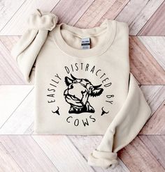 Easily Distracted By Cows Shirt, Cow Sweatshirt, Funny Cow Shirt, Humorous Shirt IMPORTANT NOTE:      - Because of high season, there are some colors runs out of stock, we will contact you if that color is out-stock     - The images on the website is only sweatshirt. PRODUCT INFORMATION     - All sizes are Unisex.     - Design will either be white or black depending on the shirt color.     - Uses a vinyl which is then pressed using an industrial heat press. It is machine washable however it is r Aesthetic Sweaters, Animal Sweater, Sweatshirt Aesthetic, Funny Cow, Funny Bears, Cow Shirt, Animal Sweatshirt, Cows Funny, Christian Sweatshirt