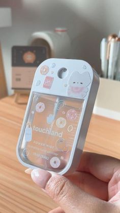 a person holding up a cell phone case with an animal sticker on the back