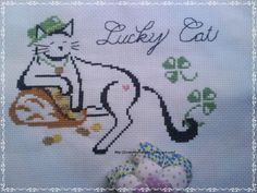 a cross stitch picture with an image of a cat