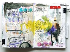 an art journal with mixed media and paper collages on the pages, including one large piece of artwork