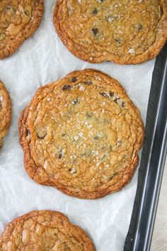 chocolate chip cookies sitting on top of a baking sheet