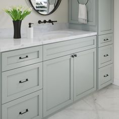 a bathroom with two sinks and a large mirror on the wall above it's cabinets