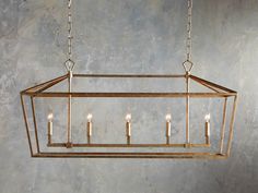 a rectangular chandelier with five candles hanging from the bottom and four lights on each end