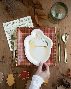 a person is holding a plate on a table