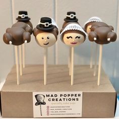 there are some cake pops that look like people wearing hats and holding wands in their hands