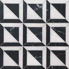 a black and white marble tile design with triangles in the middle, on top of each other