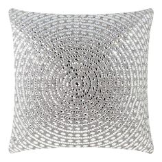 a white pillow with silver circles on it