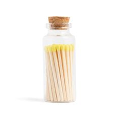 matches in a glass jar on a white background