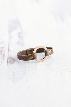 Designed to remind us that we all need to reconnect and ground to nature, our Grounding bracelet is handcrafted from the softest lamb leather and features a chunky antique brass ring with matching rivets. **Contents** * Lambskin leather, antique brass * Button clasp closure * Handmade **Care/Import** * Made in the USA **Dimensions** * One Size Fits Most: Adjustable to fit wrist sizes 6.5”-8” | Giving Bracelets Antique Brass Grounding Leather Bracelet at Free People in Grey Brass Ring, Lambskin Leather, Rivets, Womens Jewelry Bracelets, Antique Brass, Leather Bracelet, Light Grey, Jewelry Accessories, Free People