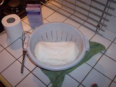 a bowl filled with food sitting on top of a counter next to a roll of toilet paper