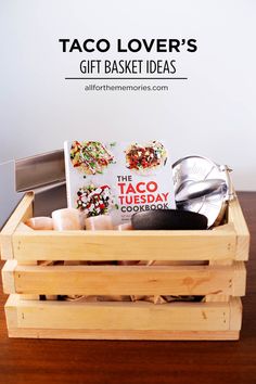 a wooden crate filled with taco lover's gift basket ideas on top of a table