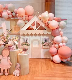 there is a doll house with balloons all around it