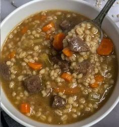 a white bowl filled with meat and barley soup