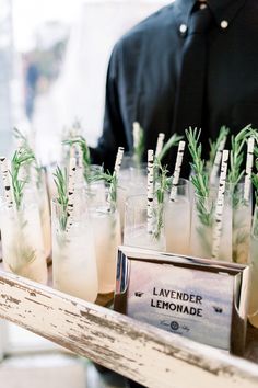 there is a tray with drinks on it and small sticks sticking out of the top