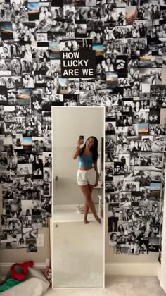 a woman taking a selfie in front of a mirror with many pictures on it