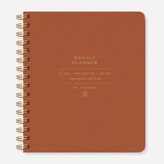 a brown planner with the words weekly planner written on it