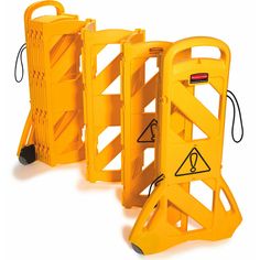 three yellow barricades with warning signs on them, all lined up against each other