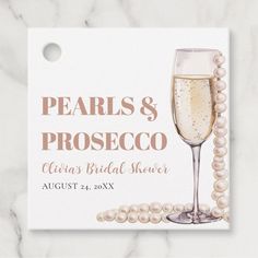 pearls and prosceco bridal shower sign on a marble background with pearl beads